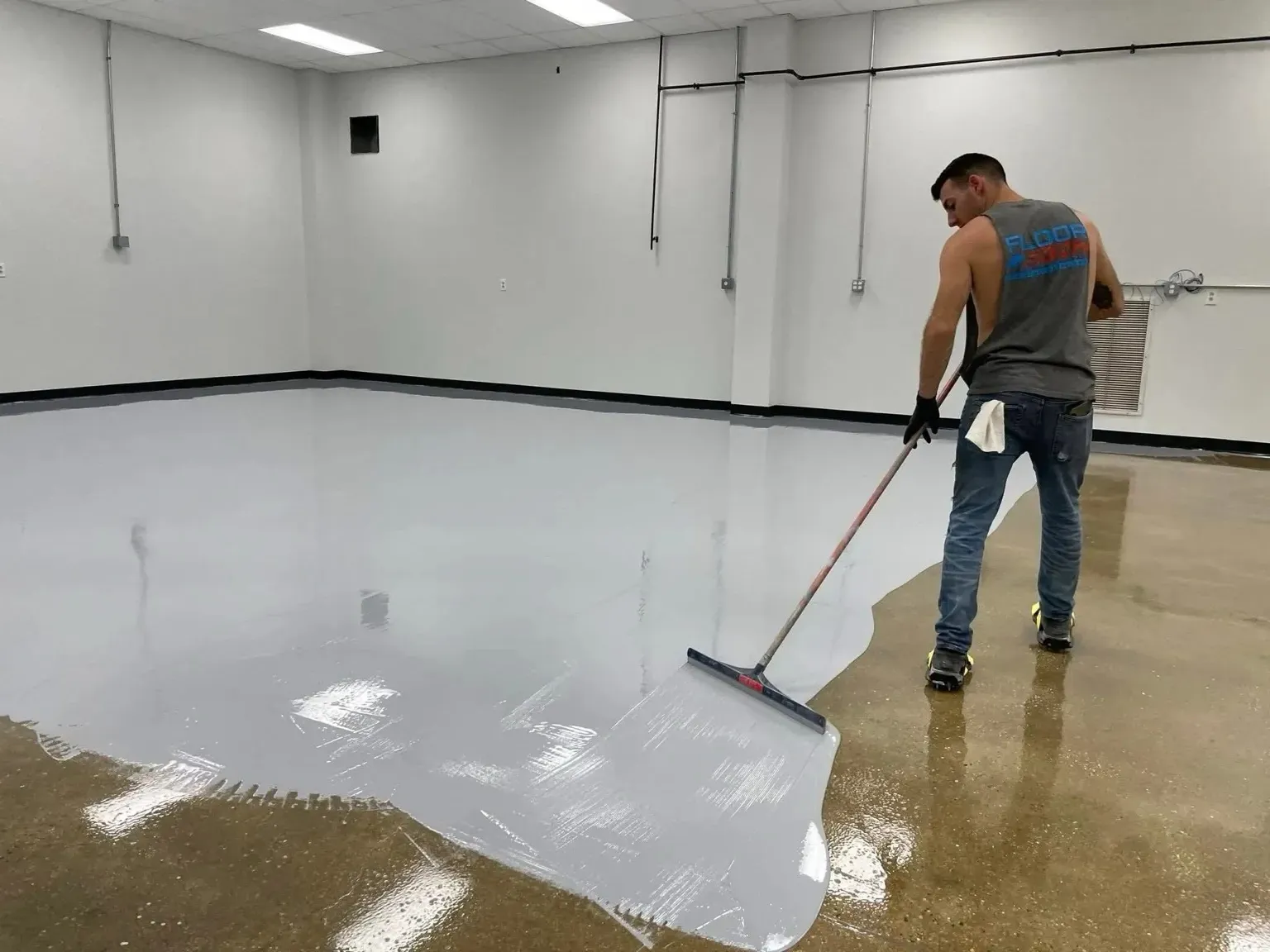 Professional installation process of garage floor coatings showing preparation and application steps
