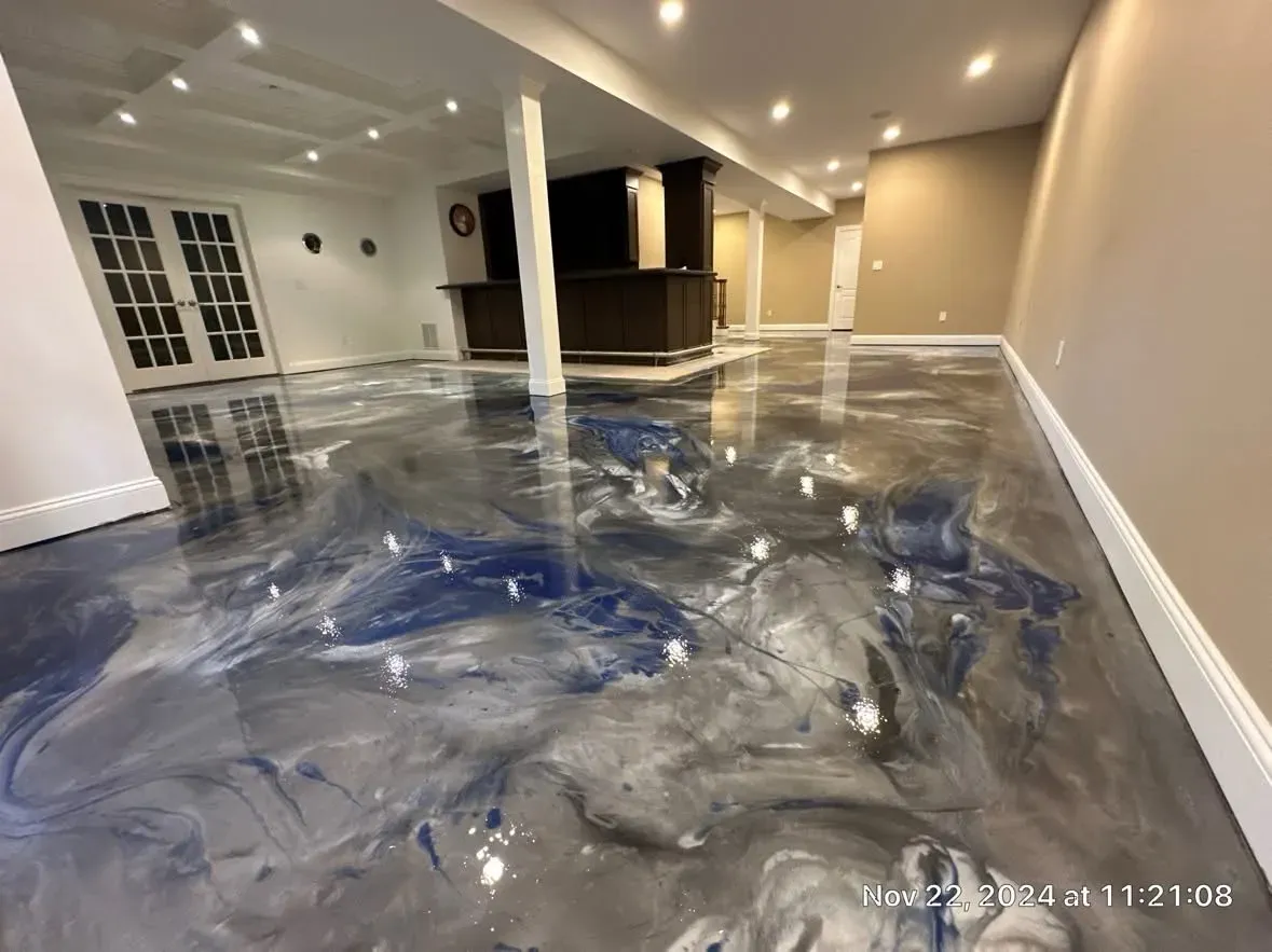 Homeowner cleaning a shiny garage floor with a mop